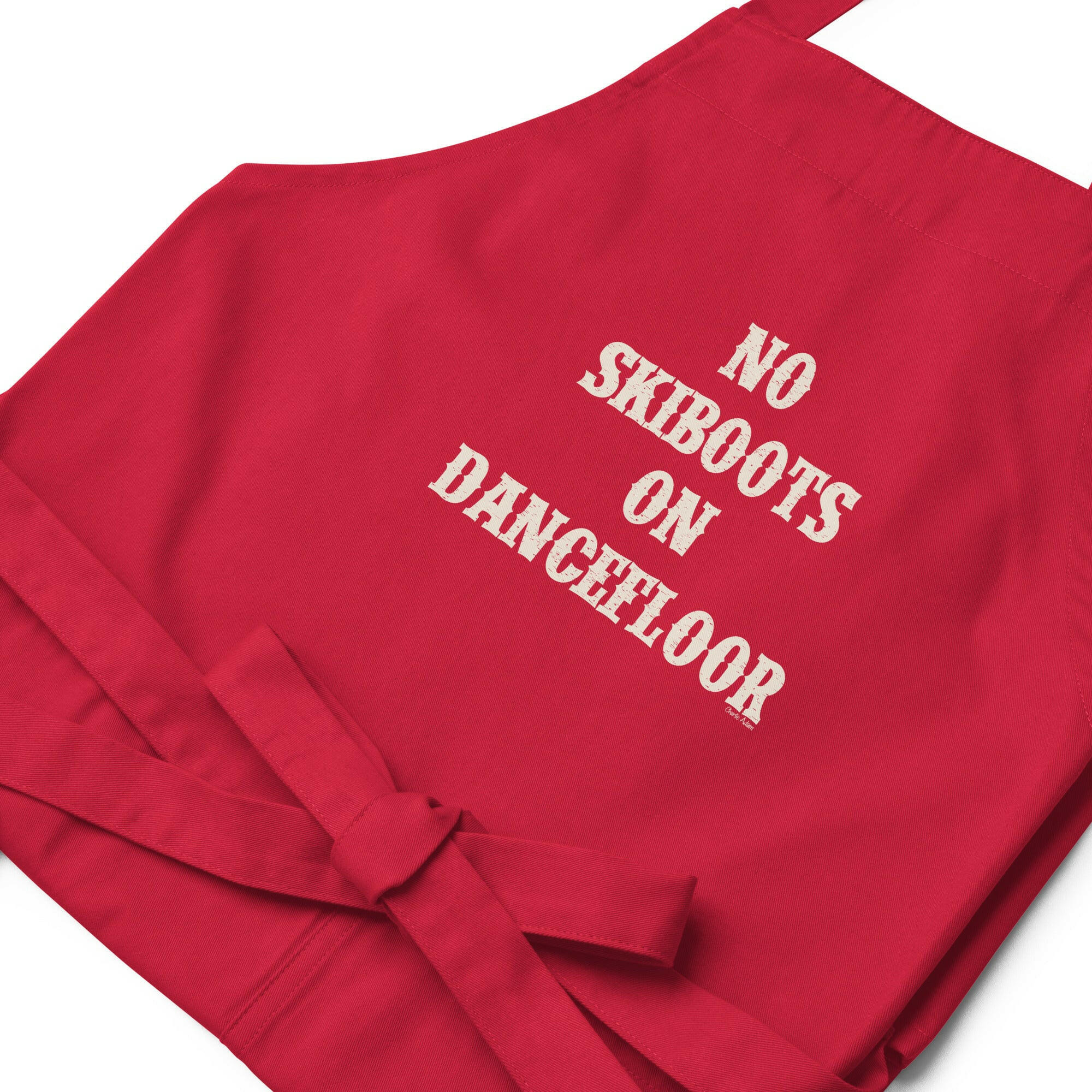 Tablier en coton biologique No Skiboots on Dancefloor sur fond sombre