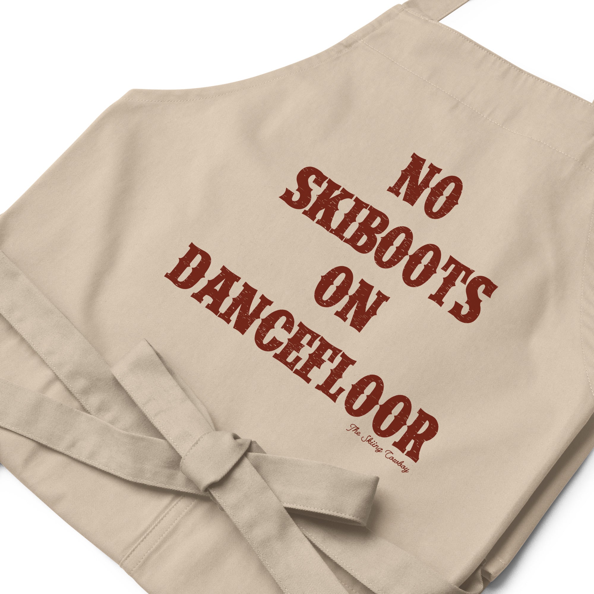 Tablier en coton biologique No Skiboots on Dancefloor sur fond clair
